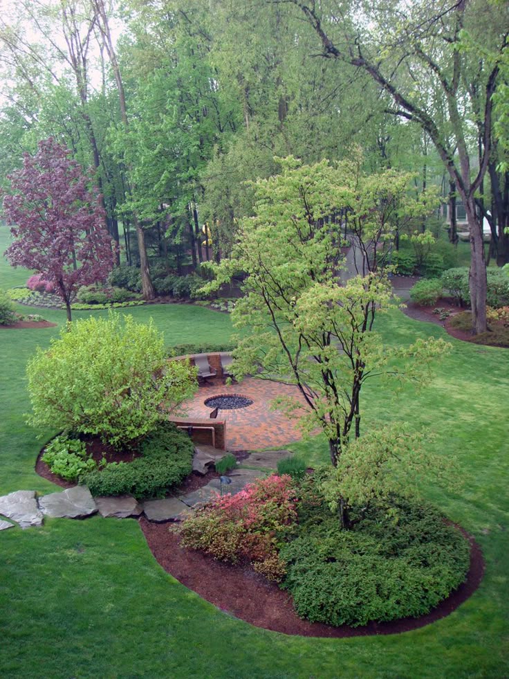 Beautifully landscaped Lancaster County backyard with a paver patio, mature trees, colorful shrubs and manicured lawn